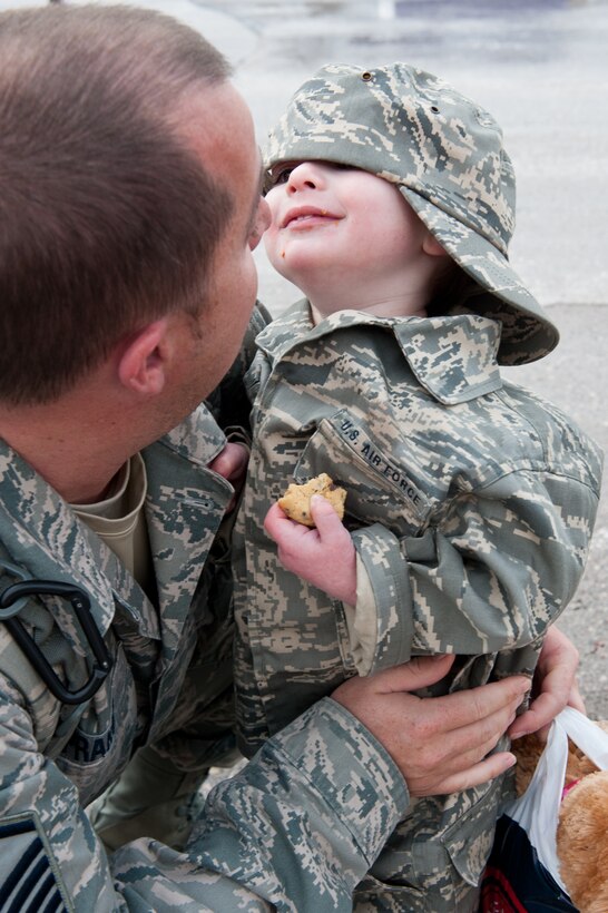 Master Sgt. Andrew Prakop, 28th Aircraft Maintenance Squadron production superintendent, reunites with his 2-year-old son, Gabriel, after returning from a six-month deployment during the homecoming event at Ellsworth Air Force Base, S.D., Jan. 25, 2012. Airmen were met by their families, friends, and colleagues who welcomed them home after supporting operations in Southwest Asia. (U.S. Air Force photo by Airman 1st Class Kate Thornton/Released)