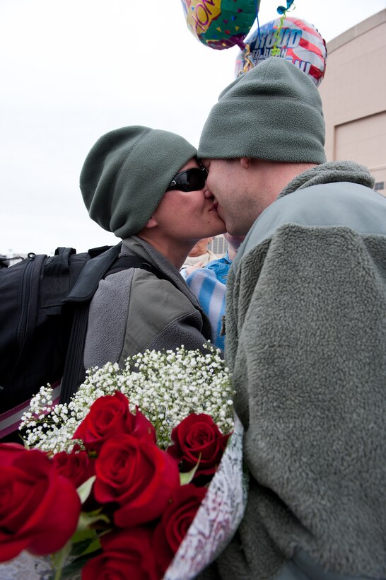 Master Sgt. Clifford Schuelke, 28th Maintenance Squadron repair and reclamation section chief, welcomes home his wife, Staff Sgt. Laura Schuelke, 28th Aircraft Maintenance Squadron communication navigation mission systems craftsman, after returning from a six-month deployment to Southwest Asia during a homecoming event at Ellsworth Air Force Base, S.D., Jan. 25, 2012. Ellsworth Airmen supported operations in the region with critical air presence, precision strike, surveillance and reconnaissance. (U.S. Air Force photo by Airman 1st Class Kate Thornton/Released)