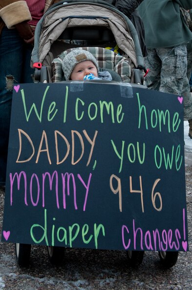 Seven month old Jordan Mcgillis awaits the arrival of his father, Airman 1st Class Christopher Mcgillis, 28th Operations Support Squadron airfield flight equipment journeyman, returning from a six-month deployment during a homecoming event at Ellsworth Air Force Base, S.D. Jan. 25, 2012. Mcgillis was among the more than 400 Airmen who returned home after supporting operations in Southwest Asia. (U.S. Air Force photo by Airman 1st Class Kate Thornton/Released)