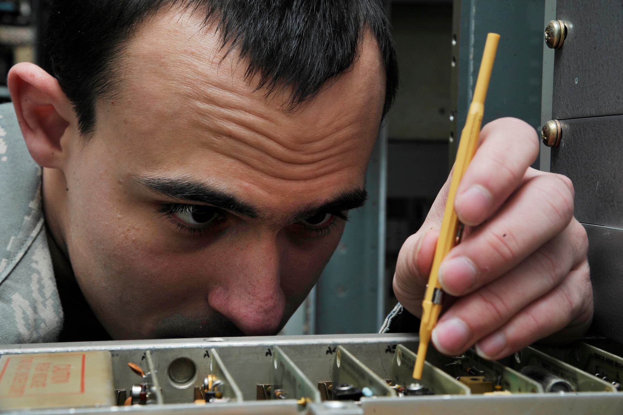 U.S. Air Force Airman 1st Class Alan Williams adjusts power levels on a Ground-to-Air transmitter during a preventative maintenance inspection Jan. 26, 2012, Eielson Air Force Base, Alaska. The inspection ensures the device uses proper power levels to send and receive transmissions. Williams is an airfield systems technician assigned to the 354th Communications Squadron. (U.S. Air Force photo by Staff Sgt. Christopher Boitz/Released)