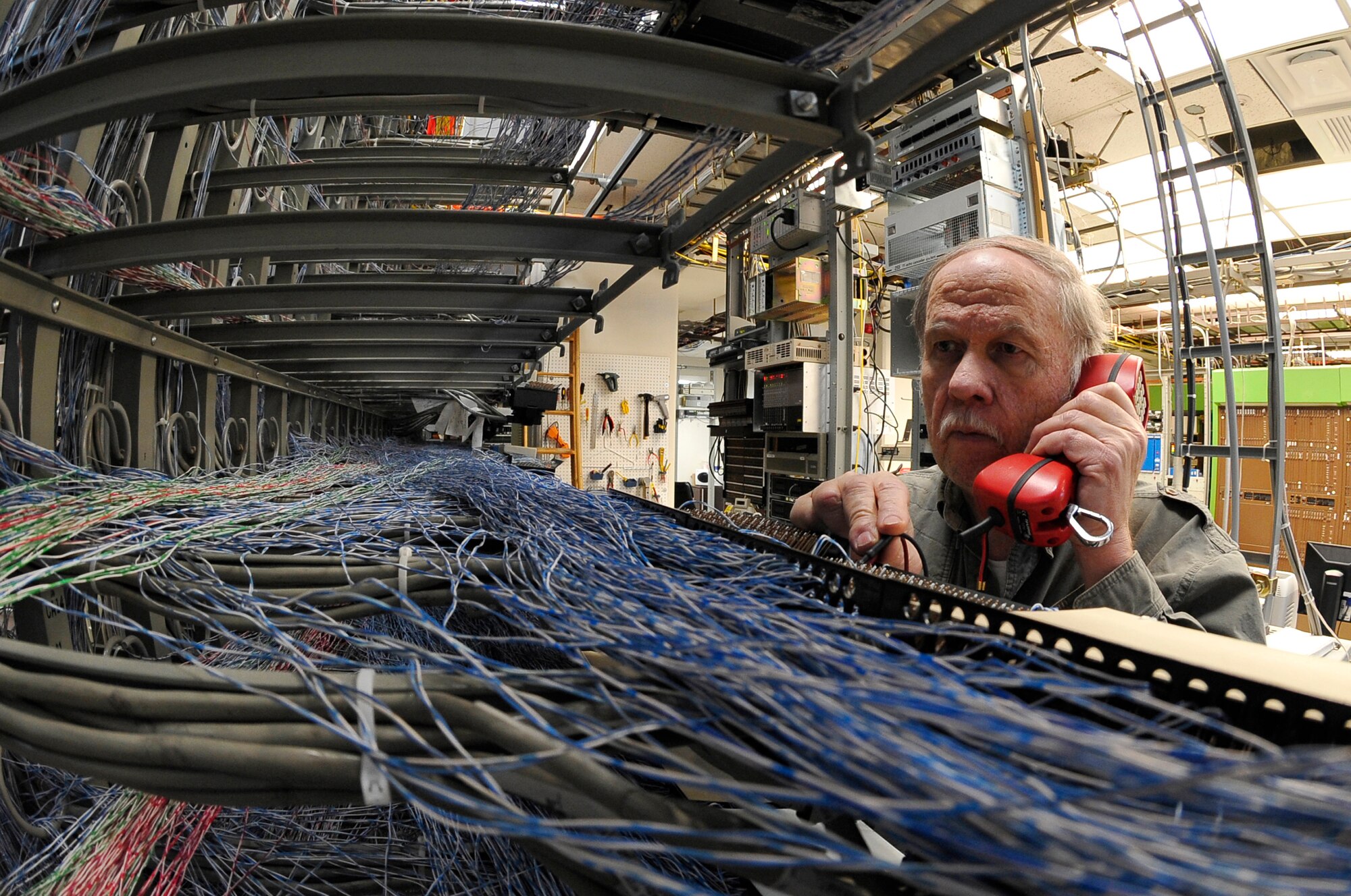 Don Hanson checks for telephone dial tones on a mainframe Jan. 26, 2012, Eielson Air Force Base, Alaska. The mainframe hosts more than 4,000 telephone lines and provides Eielson's comm. capabilities. Hanson is an Altech voice systems network technician assigned to the 354th Communications Squadron. (U.S. Air Force photo by Staff Sgt. Christopher Boitz/Released)