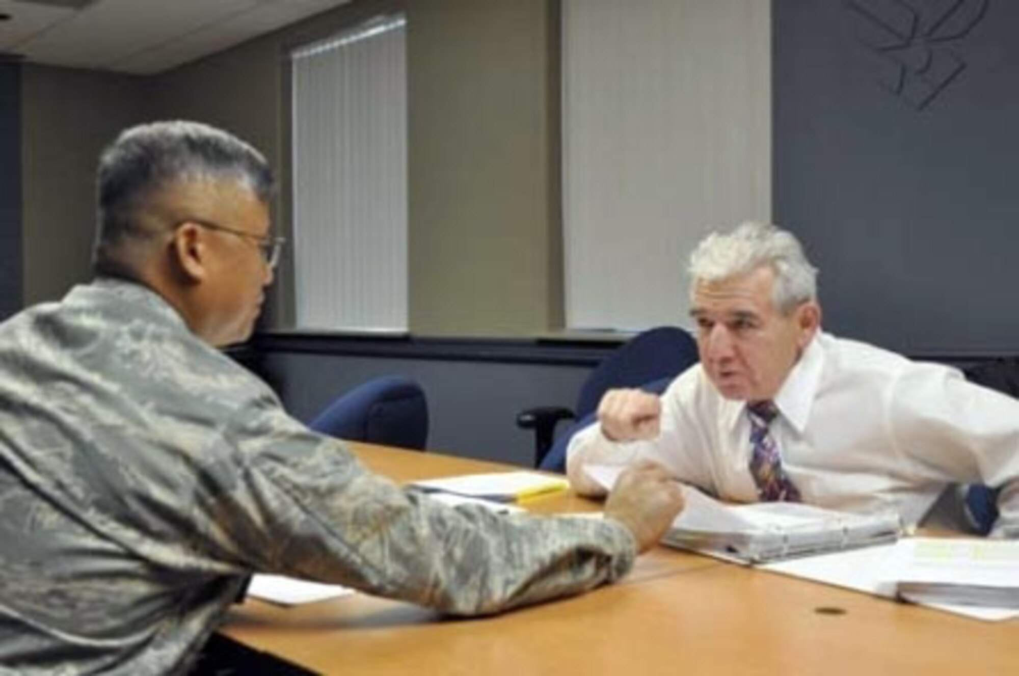 Mr. Anthony Noriega (right), 4th Air Force manpower director, provides career transition information to Lt. Col. Ronald Dollesin, 4th AF maintenance section, during the January 20-21, 2012, unit training assembly. Fourth Air Force and the Air Force Reserve Command’s other two numbered air forces (10th AF and 22nd AF) are being downsized to accommodate reshaping of the command’s mission objectives to meet future Defense Department goals and resource requirements. (U.S. Air Force photo / Maj. Andra Higgs)