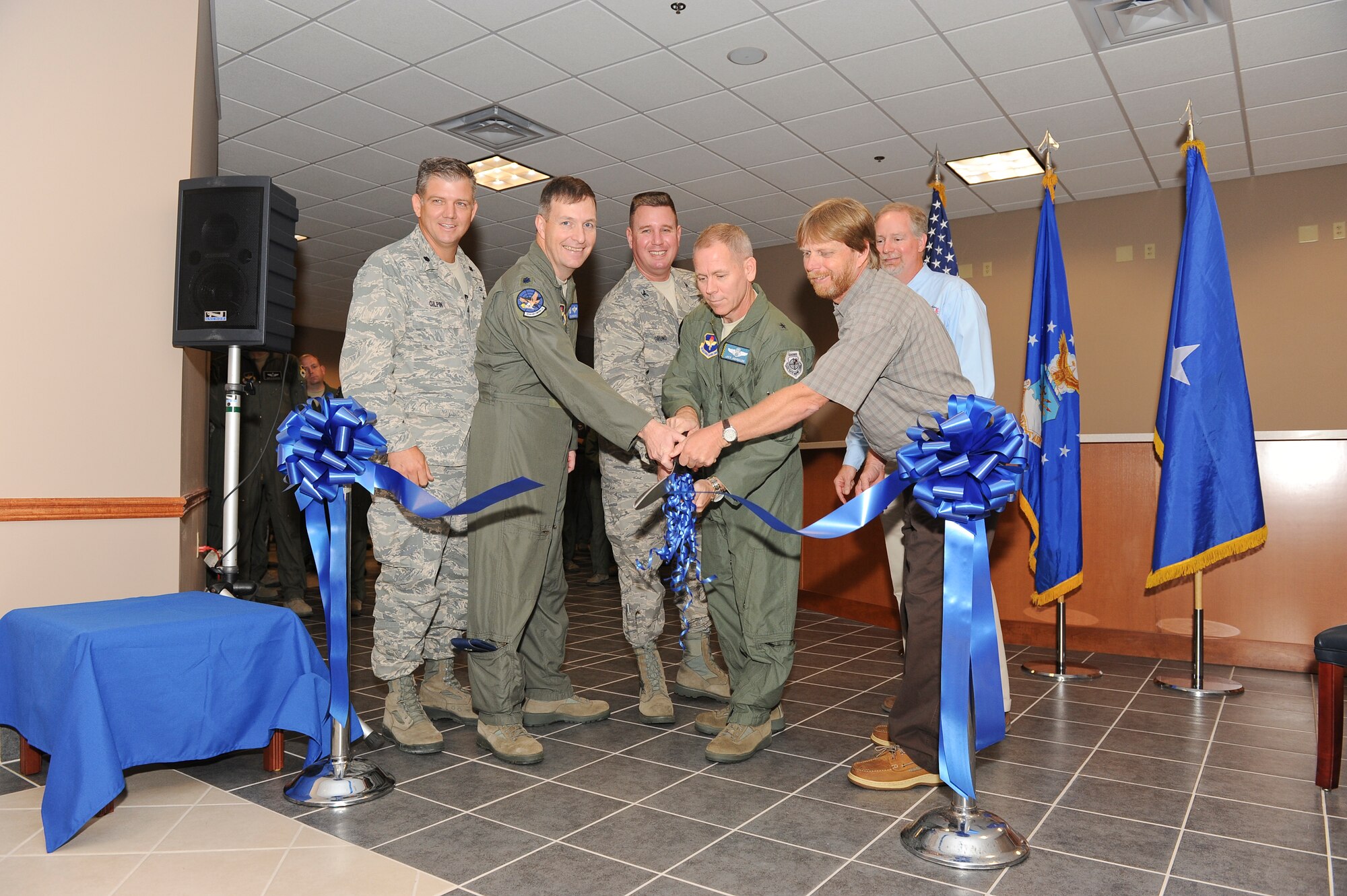 Brigadier General John McMullen, 325th Fighter Wing commander, and other key members involved in the development of the new Air Control Squadron Operations Training Complex, cut the ribbon at the official opening ceremony Jan. 26. (U.S. Air Force photo by Lisa Norman)