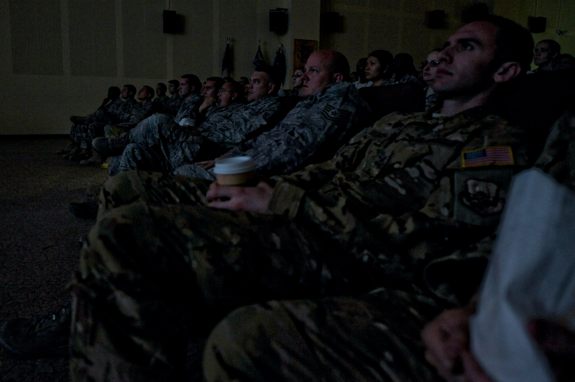 Members of the 332nd Air Expeditionary Wing watch the movie "Red Tails" at an undisclosed location in Southwest Asia, Jan. 27, 2012. The 300-seat auditorium was packed with 332nd AEW members, to include those who are geographically separated from their main base. (U.S. Air Force photo by Staff Sgt. Joshua J. Garcia/Released)