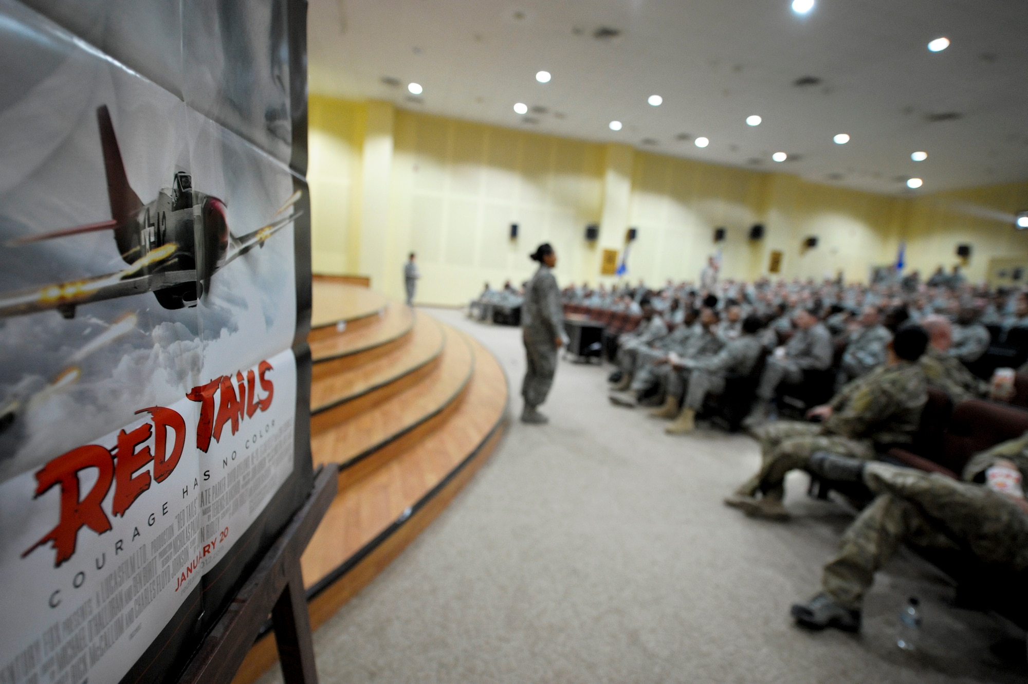 Members of the 332nd Air Expeditionary Wing settle in their seats prior to watching the movie "Red Tails" at an undisclosed location in Southwest Asia, Jan. 27, 2012. Since wing members are carrying on the lineage of the 332nd mission, 332nd AEW airmen were given the privilege of watching the first showing of the movie at a deployed location.(U.S. Air Force photo by Staff Sgt. Joshua J. Garcia/Released)