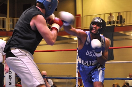 Irby Burnett, senior airman from the 60th Maintenance Squadron, Travis Air Force Base, Calif., lands a punch on Jesse Richardson during the Air Force Box-Off Tournament at the METC Campus Fitness Center Saturday. (U.S. Air Force photo/ Deyanira Romo Russell)
