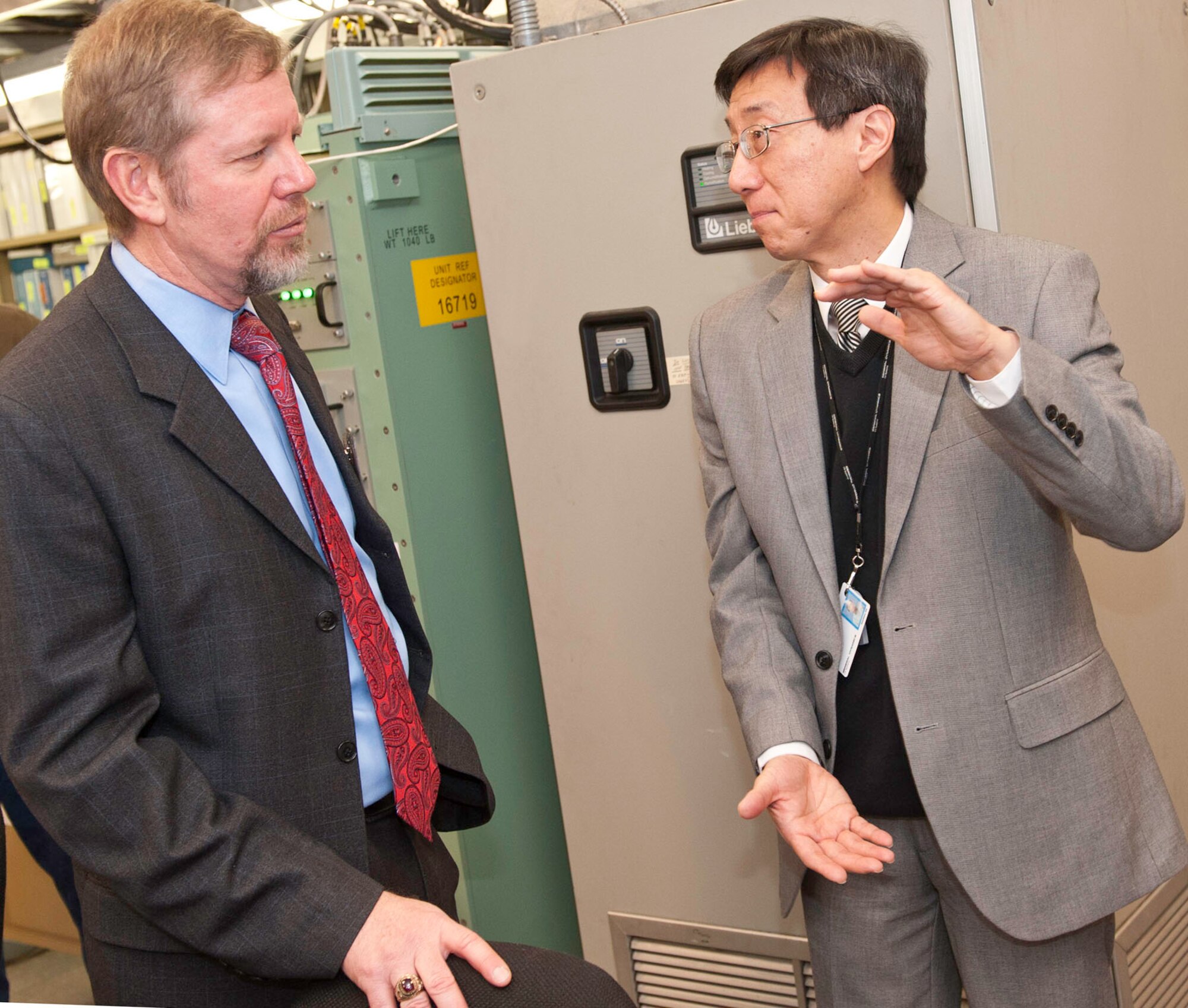 Scott Hardiman (left), Space and Nuclear Networks Division acting chief, speaks to Chao-Min King, General Dynamics Defense Injection/Reception Emergency Action Message Command and Control Terminal (DIRECT) program manager, at the contractor's facility in Needham, Mass., Jan. 9. The Electronic Systems Center recently transitioned the DIRECT program to Warner Robins Air Logistics Center, Ga., for continuing sustainment. (Photo by Steve Mason, General Dynamics C4 Systems)
