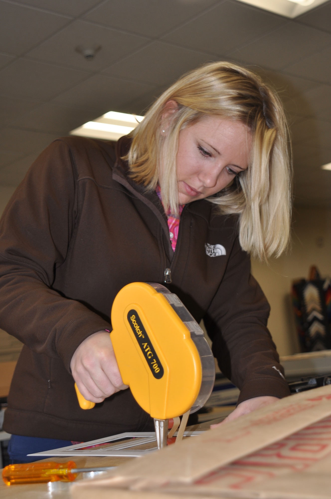 Danae Paul, Frame Shop customer, uses an adhesive gun on the matting for her project Dec. 29. Her and her husband were preparing frames to hold holiday pictures. “We went through the framing class a few years ago – this is a great opportunity to do hands-on work for yourself.” (U.S. Air Force photos by Scott King) 