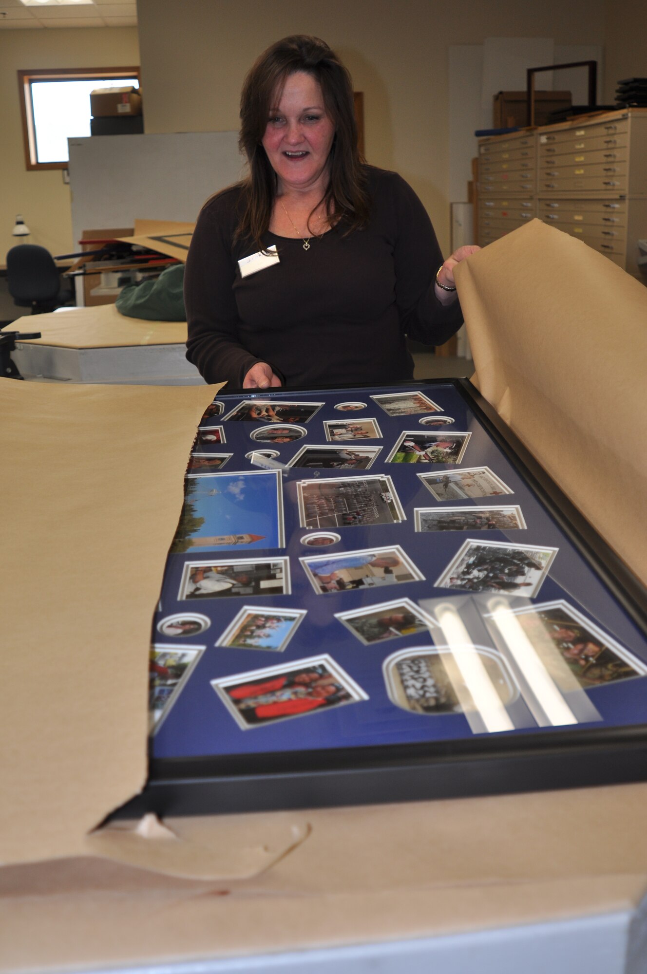 Lori Flynn, 92nd Force Support Squadron Frame Shop manager, wraps up a finished memento for a retiring master sergeant Jan. 4. She is proud of what they do. “We are important to our patrons because we save them money and it’s a world of fun for them to work on their own projects. We do something different every day – couldn’t think of a better place to work.” (U.S. Air Force photos by Scott King) 