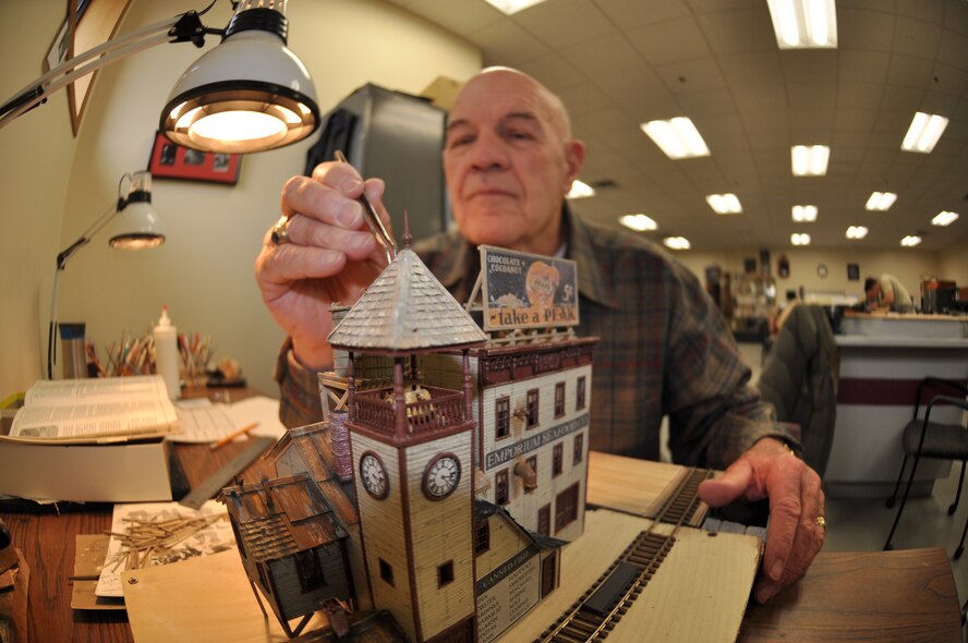 Ron Peterson, a retired lieutenant colonel, puts the finishing touches on his ‘Emporium Seafood Company’ building as part of a train set he is working on Jan. 3. He has been using the Fairchild Frame Shop since 1975 to build his train sets. He goes there every Tuesday and Thursday to work on his projects and is very grateful he can use their facility. “I’ve been coming here for more than 30 years,” he said. “I get more work done out here than at home – I love the place.” (U.S. Air Force photos by Scott King) 