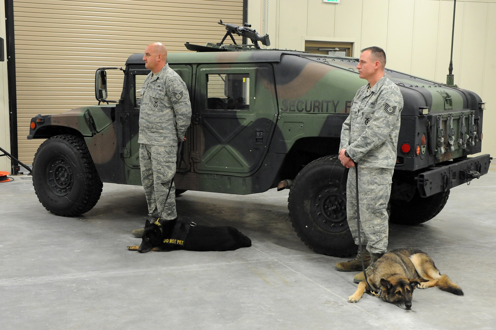 Staff Sgt. Eric Magnuson (left) with MWD Liska and Tech. Sgt. Jason Hanisko with MWD Arek, all with the 75th Security Forces Squadron Military Working Dog Section, attend the ribbon cutting. (U.S. Air Force photo by: Alex Llyod)