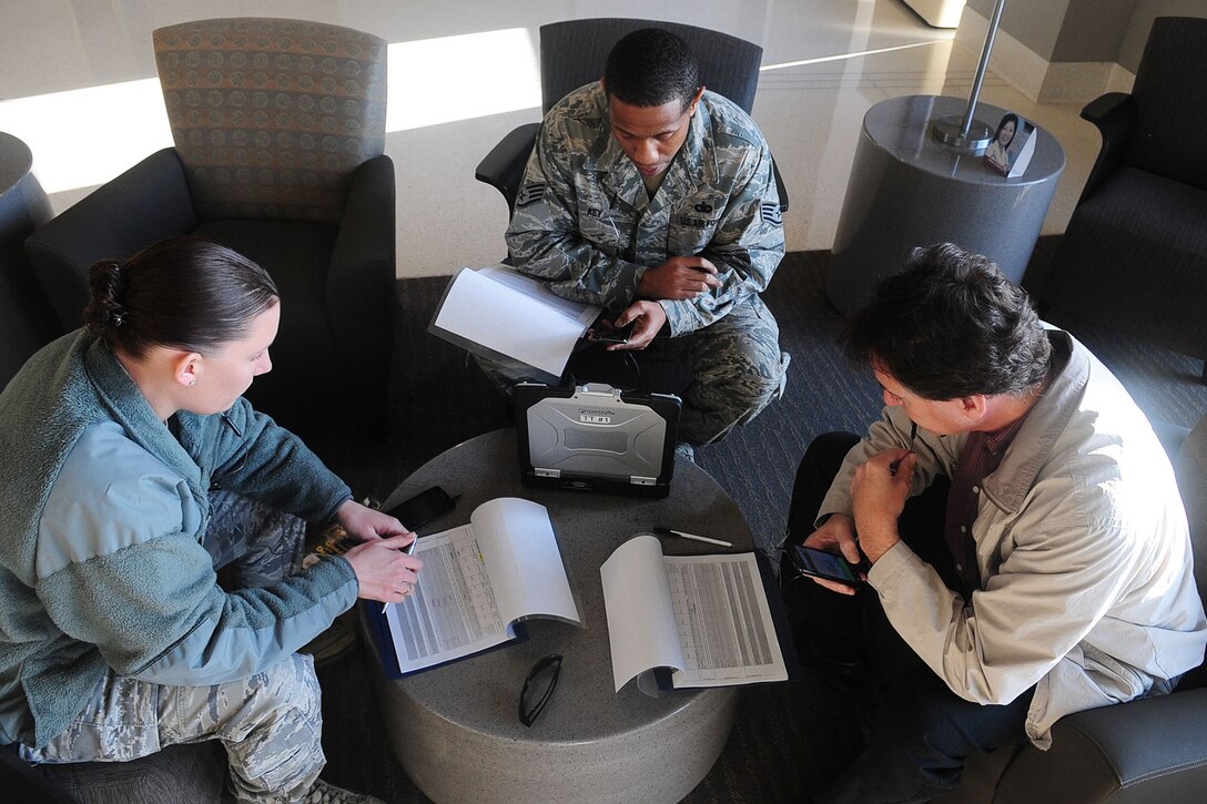U.S. Air Force Staff Sgts. Sarah Kearney, left, Oris Key, center, both from the 633rd Security Forces Squadron, and Ken Hughes, Air Force Integrations Center systems engineer, analyze data during a Joint Expeditionary Force Experiment exercise at Langley Air Force Base, Va., Jan. 25, 2012. The month long exercise was held to assess multiple cellular solutions for enhanced speed and cost reductions. (U.S. Air Force photo by Staff Sgt. Ashley Hawkins/Released)