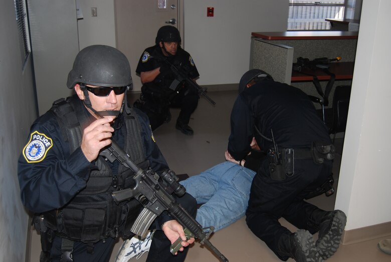PETERSON AIR FORCE BASE, Colo. — Members of the 21st Security Forces Squadron apprehend a gunman during an active shooter exercise Jan. 25. The purpose of the exercise was to evaluate and ensure preparedness of all Airmen in case of a real-world event. (U.S. Air Force photo/Lea Johnson)
