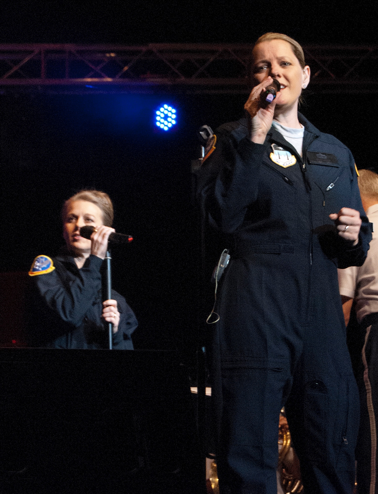 Tech. Sgt. Julie Bradley, right, sings during an Air Force Academy Band performance in the Arnold Hall Theater Jan. 26, 2012. The performance was part of a resiliency day presentation for both permanent party staff and cadets. Bradley is a vocalist and the group leader for the Blue Steel ensemble. Also pictured, left, is Tech. Sgt. Krista Joyce, who joined the band in September 2011. (U.S. Air Force photo/Don Branum)