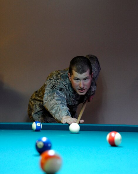 LAUGHLIN AIR FORCE BASE, Texas – An Airman lines up a shot on one of the pool tables at the Stripes Enlisted Lounge here Jan. 20, More than 90 volunteers contributed 2,400 man hours in the creation of the new enlisted club. (U.S. Air Force photo/Airman 1st Class Nathan L. Maysonet) 