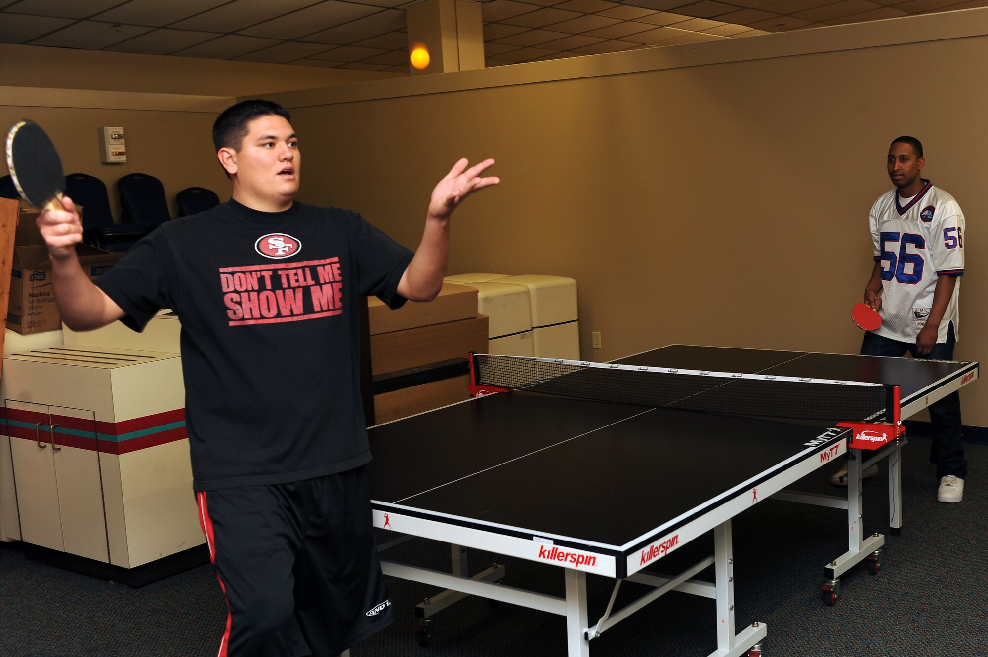 U.S. Air Force Senior Airman Daniel Serrano, 824th Base Defense Squadron, takes his serve during a ping pong tournament game against Senior Airman Christopher Kingsbury, 23d Medical Group, at The Spot at Moody Air Force Base, Ga., Jan. 26, 2012. The tournament was part of the first annual Martin Luther King Jr. birthday diversity tournament held here. (U.S. Air Force photo by Staff Sgt. Ciara Wymbs/Released)  
