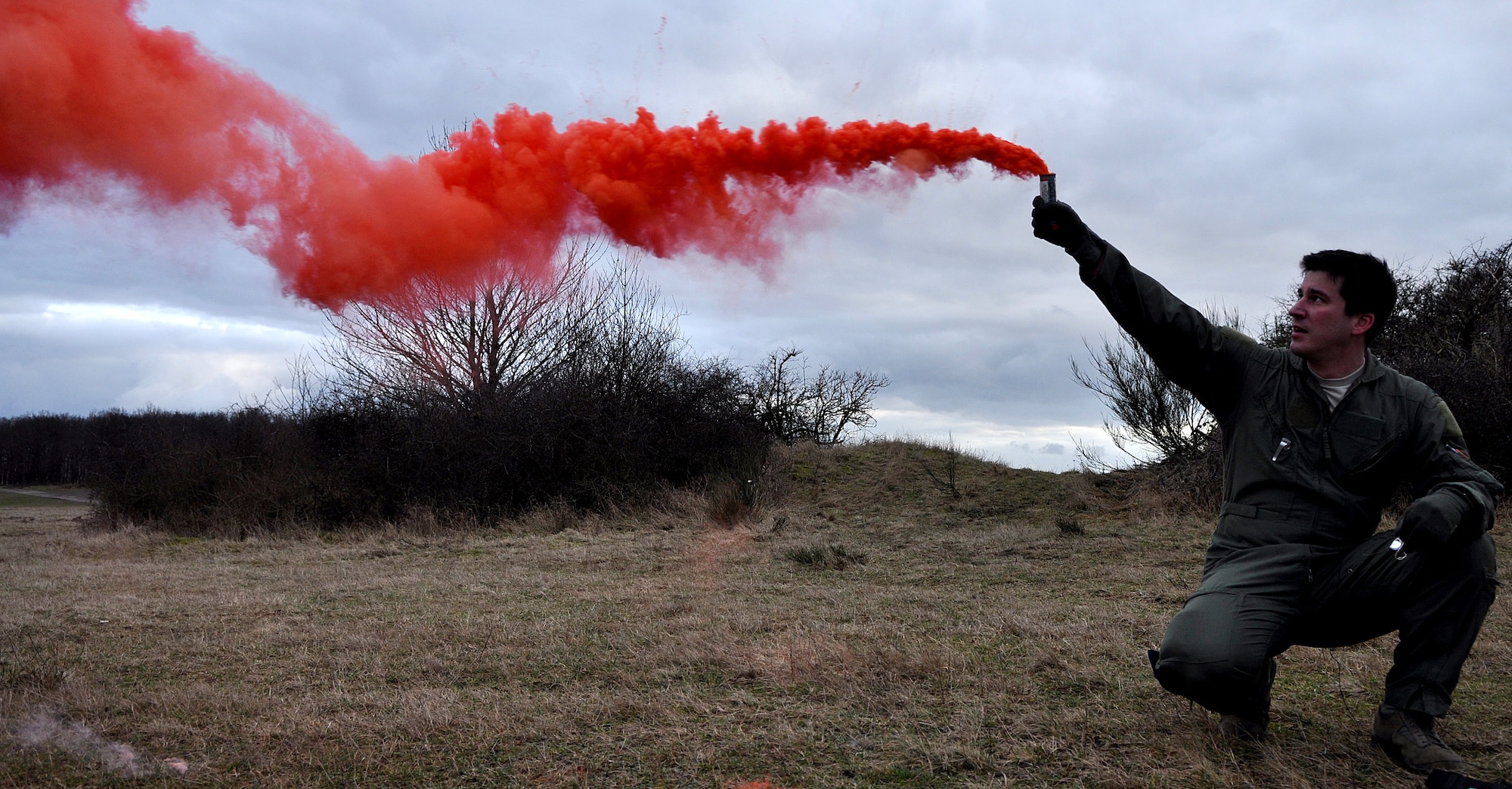 BAUMHOLDER, Germany – U.S. Air Force Capt. James Schmidt, 81st Fighter Squadron pilot, raises a signal smoke flare during joint forces close air support and combat search and rescue training at the Baumholder Major Training Area here Jan. 23 to signal a U.S. Army AH-64 Apache helicopter crew participating in the training. The training integrates Army and Air Force resources to more accurately simulate the real-life CSAR and CAS scenarios encountered in deployed locations. The goal of this training is to develop tactics, techniques and procedures between military branches to enhance interoperability. (U.S. Air Force photo/Senior Airman Natasha Stannard)