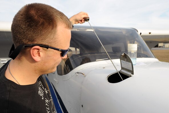 U.S. Air Force 2nd Lt. Derek Dillard, 23d Logistics Readiness Squadron readiness officer, checks oil levels prior to pilot training at Valdosta Regional Airport, Ga., Jan. 25, 2012.
Dillard’s goal is to become a pilot in the Air Force. (U.S. Air Force photo by Staff Sgt. Ciara Wymbs/Released) 
