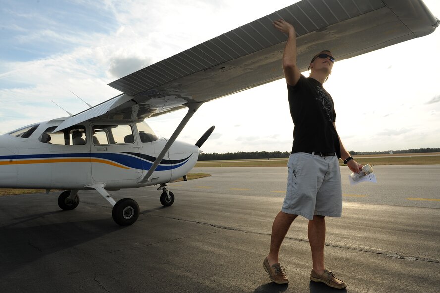 U.S. Air Force 2nd Lt. Derek Dillard, 23d Logistics Readiness Squadron readiness officer, completes a pre-flight inspection prior to pilot training at Valdosta Regional Airport, Ga., Jan. 25, 2012. Dillard takes flight lessons up to three times per week. On average, receiving a piloting license can take at least four months. (U.S. Air Force photo by Staff Sgt. Ciara Wymbs/Released) 
