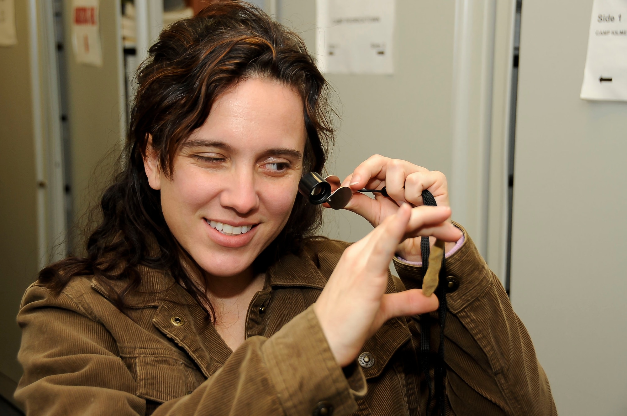 Adrienne Duryee, 87th Civil Engineer Squadron staff archeologist from Morristown, N.J., takes a closer look an 8,000-year-old projectile point found on Joint Base McGuire-Dix-Lakehurst property. The archeological department has found everything from ancient Native American artifacts to World War II-era remnants here. (U.S Air Force photo by Airman Ryan Throneberry/Released)