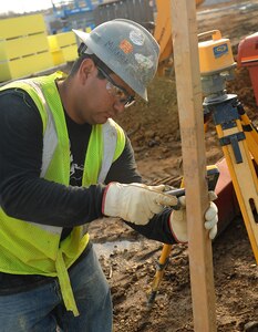 Jose Miranda, carpenter,  checks the elevation at the new AIT dining facility site at Fort Eustis, Va., Jan. 24, 2012. The new dining facility scheduled to be open this fall with a feeding capacity of up to 2,600 soldiers. (U.S. Air Force photo by Staff Sgt. Antoinette Gibson/Released)