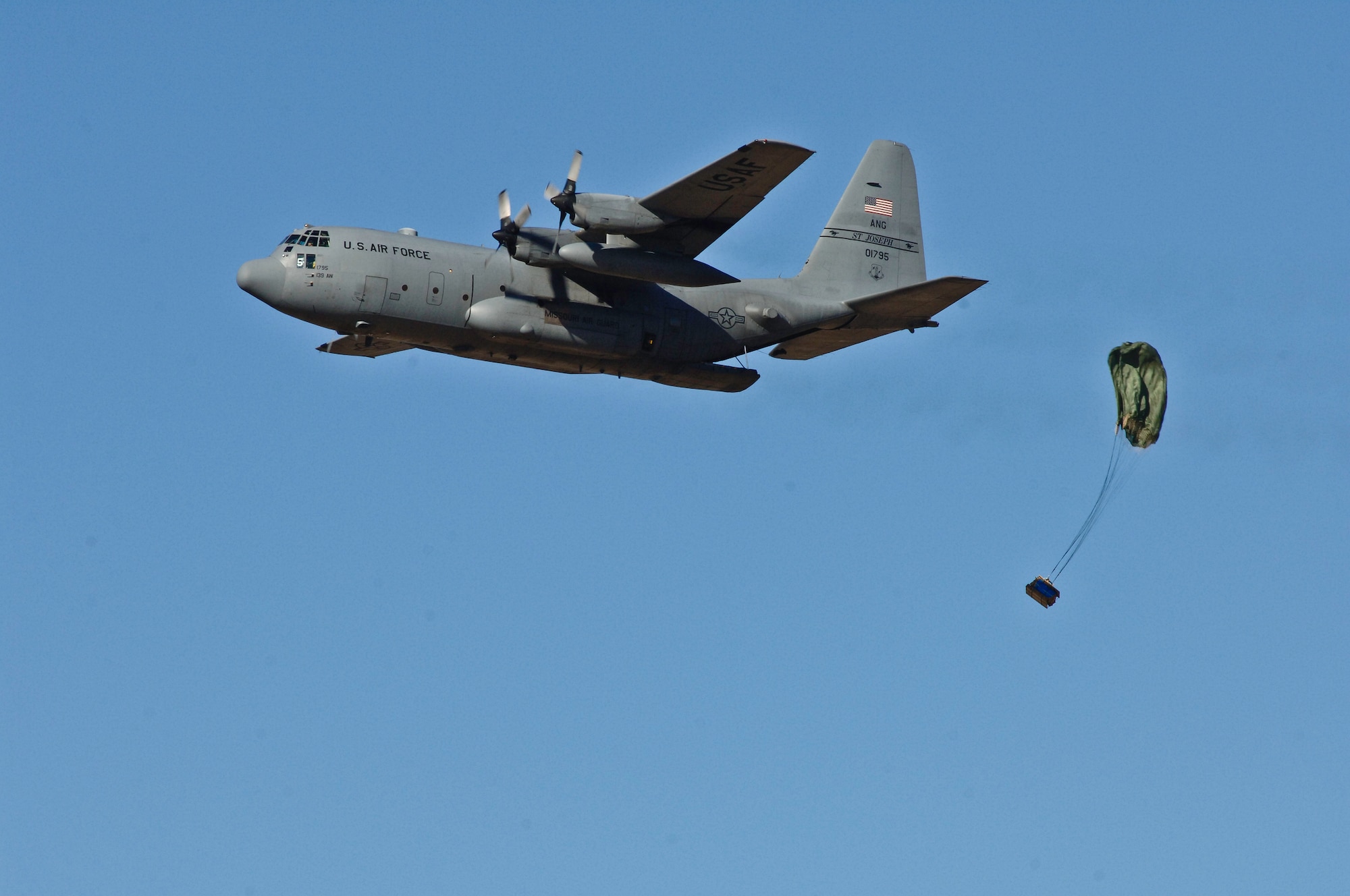 A Missouri Air National Guard C-130 cargo aircraft employs a low-cost, low-altitude airdrop near Rosecrans Air National Guard Base, St. Joseph, Mo., Jan. 26, 2012. The airdrop was part of the Advanced Airlift Tactics Training Center’s 30th Annual Tactics and Intelligence Symposium. (Missouri Air National Guard photo by Tech. Sgt. Erin Hickok)