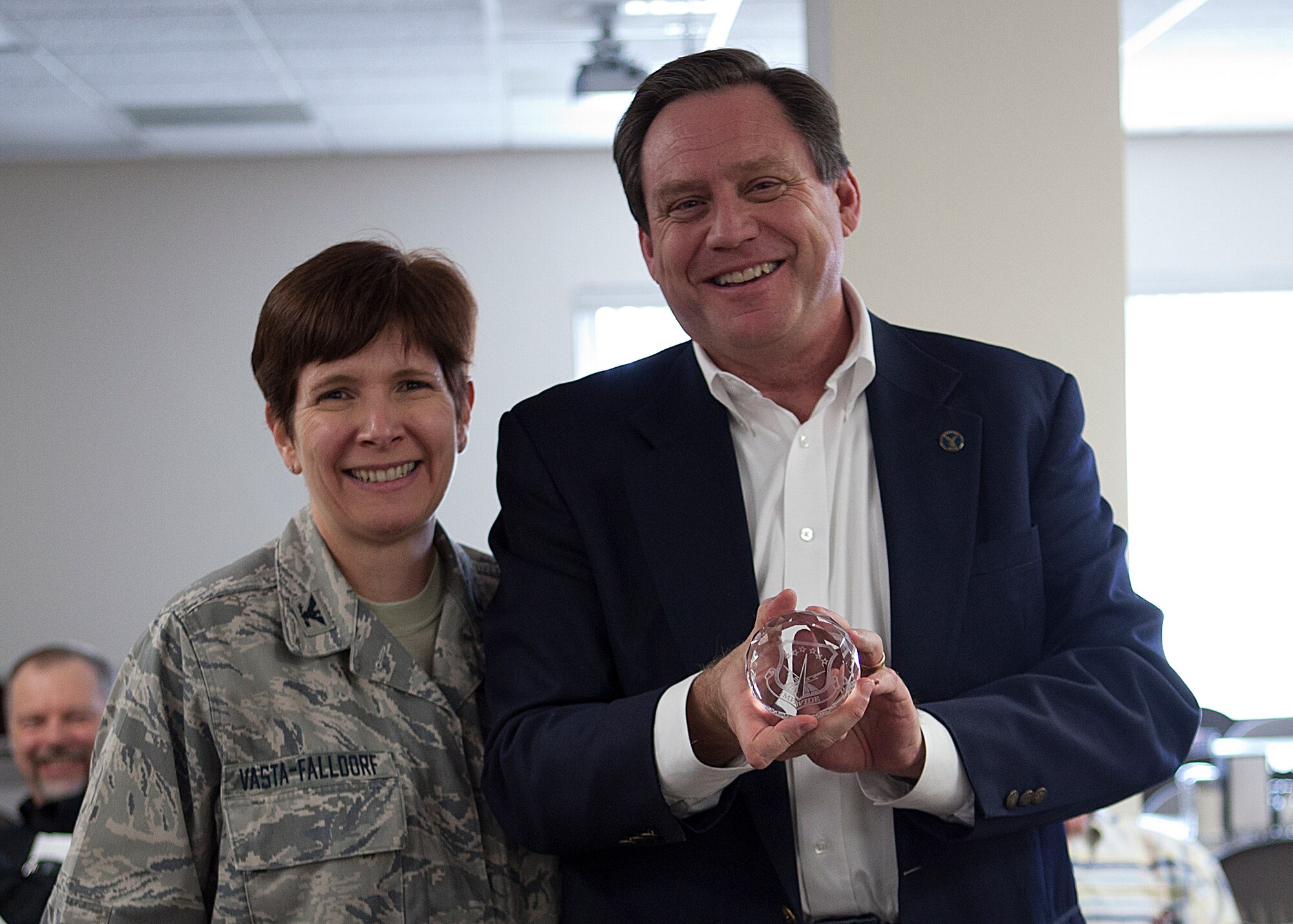 Col. Fran Vasta-Falldorf, 90th Medical Group commander, presents Scott Meier, former Military Affairs Committee chairman, with a token of appreciation for his service as MAC chairman throughout the past year. The MAC held its first meeting of the year Jan. 20 in the National Guard Dining Facility, Cheyenne, Wyo. (U. S. Air Force photo by Matt Bilden)