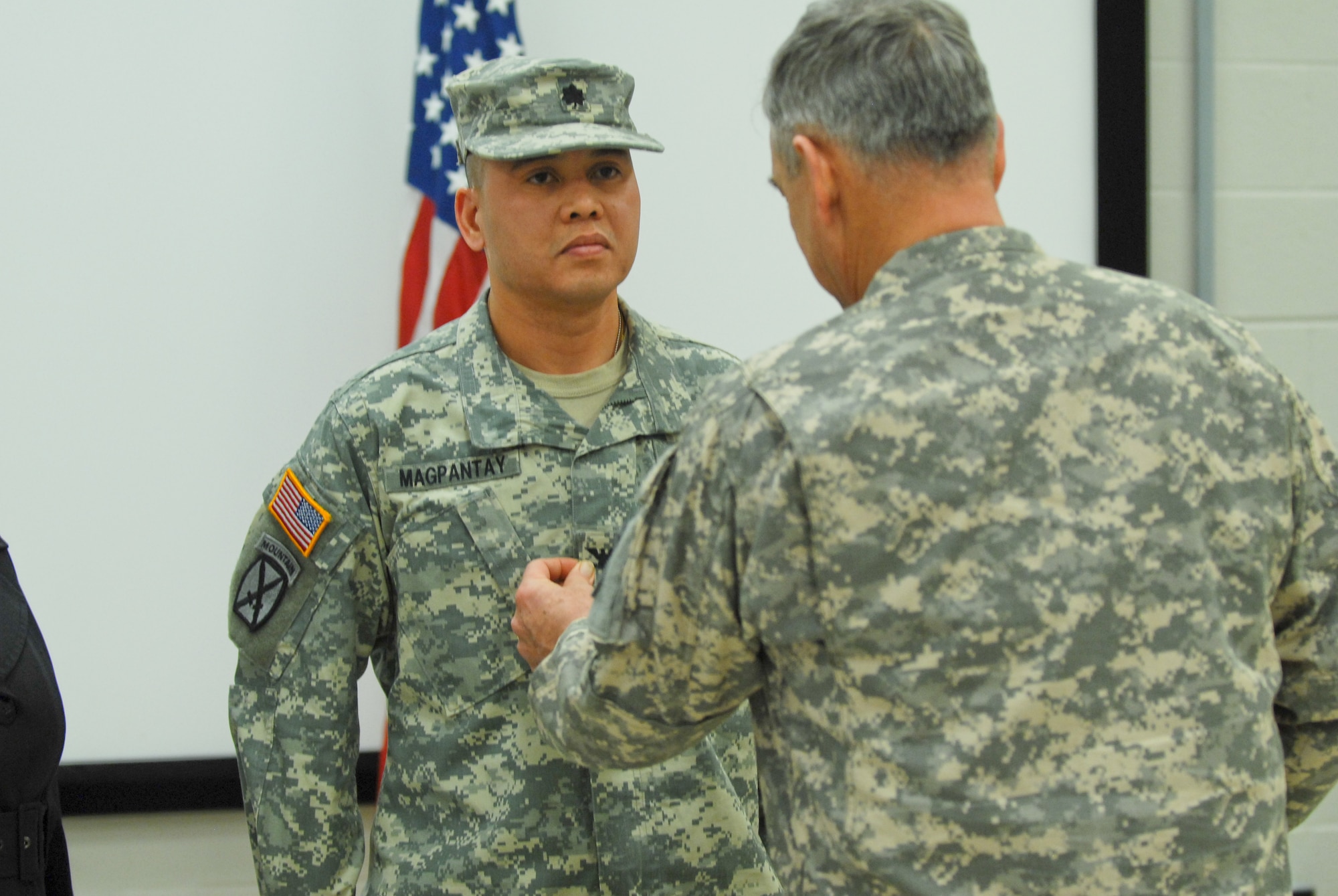 The 99th Regional Support Command Soldier Readiness Processing Team Chief, Lt. Col. Danny Magpantay receives a promotion to colonel during a ceremony held Jan. 17 at the Maj. John P. Pryor Army Reserve Center here. The 99th Regional Support Command provides base operations support to more than 51,000 Army Reserve Soldiers, units, facilities and equipment in its thirteen-state area of responsibility. (U.S. Army photo by Sgt. 1st Class Alyn-Michael Macleod/Released)