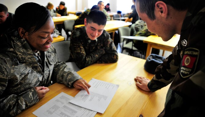 Staff Sgt. Michelle Fedrick and Pvt. Erkin Sainabidin-uulo are quizzed by Capt. Ruslan Kachonov on Jan. 26, 2012, during a language exchange between the Transit Center at Manas and the Koi Tash NCO Academy in Koi Tash, Kyrgyzstan. Twenty people attended the exchange covering conversation basics in English, Russian and Kyrgyz. Sainabidin-uulo is a student at the NCO Academy and Kachonov is a tactics instructor. Fedrick is an aviation resource management craftsman with the 817th Expeditionary Airlift Squadron deployed from Joint Base Lewis-McChord, Wash. (U.S. Air Force Photo/Staff Sgt. Angela Ruiz)