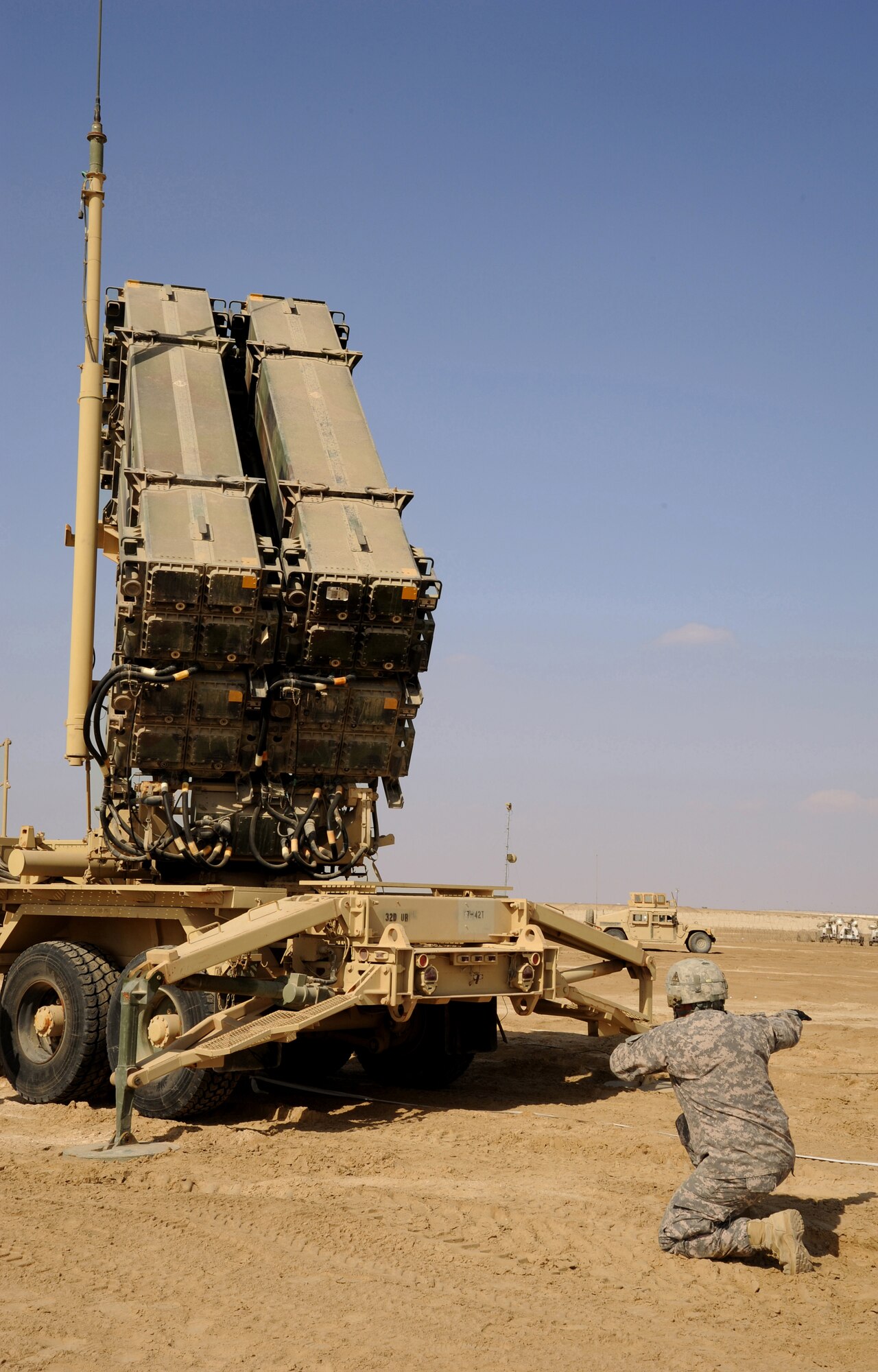 SOUTHWEST ASIA - Army Pfc. Sean Litchford directs the movements of a Patriot launching station to ensure it's clear and ready to engage targets during a mobility exercise Jan. 23, 2012.  Charlie Battery, 3rd Battalion, 4th Air Defense Artillery Regiment conducted the exercise to maintain their ability to move their battery if needed. Litchford, a Bradenton, Fla. native, is deployed from Fort Bragg, N.C. (U.S. Air Force photo/Tech. Sgt. Arian Nead)
