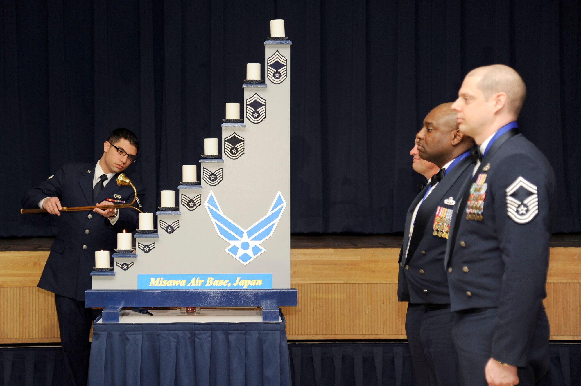 MISAWA AIR BASE, Japan - Misawa's newest Chiefs watch as Airman 1st Class Ivan Abreu, 35th Civil Engineer Squadron structural apprentice, lights the A1C candle during the Chief Recognition Ceremony here, Jan. 25. Each candle represents an enlisted grade in the U.S. Air Force up to chief. Chief Master Sergeant is the highest enlisted rank and is only held by one percent of all enlisted members. (U.S. Air Force photo/Tech. Sgt. Marie Brown)
