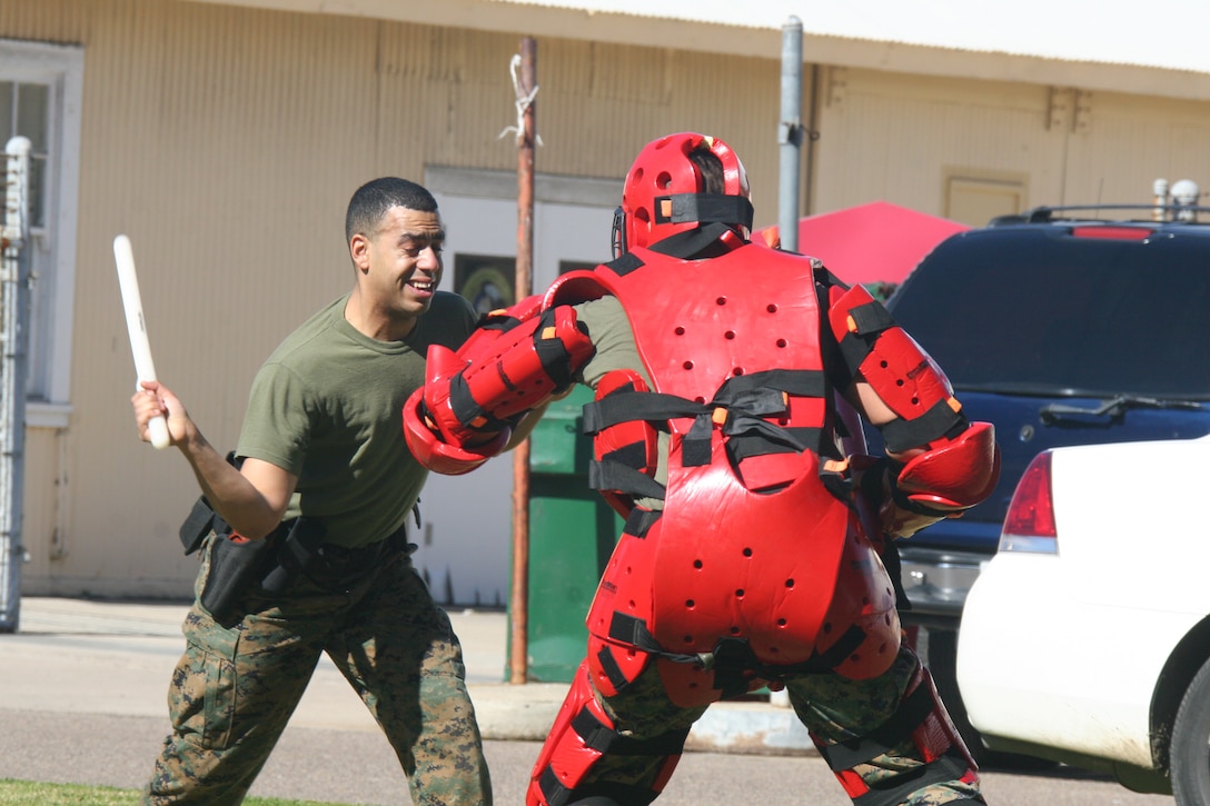 Lance Cpl. Dennis Contreras, postal clerk, Headquarters and Service Battalion, delivers baton strikes and blocks so that he can subdue the "suspect" Jan. 27 during a level one of Oleoresin Capsicum spray course aboard Marine Corps Recruit Depot San Diego. Marines completed this course as a part of Security Augmentation Force training. This gave them a first hand experience on the OC spray effects and situations they may face.