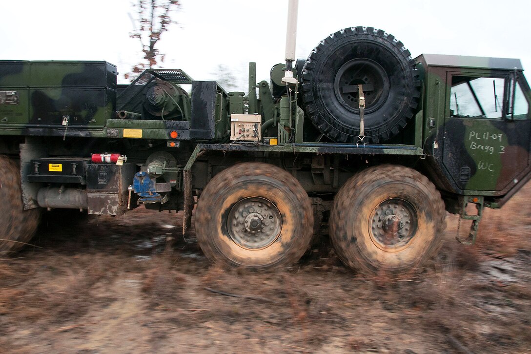 Paratroopers operating a tactical truck wrecker drive away after pulling several vehicles from soft mud at the Joint Readiness Training Center on Fort Polk, La., Jan. 25, 2012. The brigade is participating in a month-long rotation to prepare for a deployment to Afghanistan.