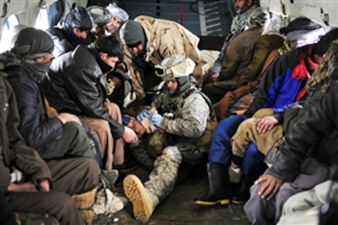 U.S. Air Force Master Sgt. Chris Banks attends to injured villagers onboard a Mi-17 helicopter in Shewa village in Afghanistan's Badakhshan province on Jan. 24, 2012.  Banks is a medic assigned to the 438th Air Expeditionary Advisory Group.  American and Afghan aircrews conducted rescue missions to evacuate inhabitants injured by an avalanche in Shewa village.  