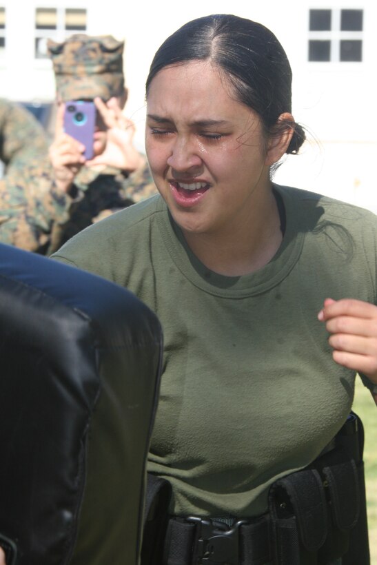 Lance Cpl. Chae Williams, correspondent clerk, Headquarters and Service Battalion, performs forward and reverse strikes on a bag during station four of a level one of Oleoresin Capsicum spray course Jan. 27 aboard Marine Corps Recruit Depot San Diego. Marines completed this course as a part of Security Augmentation Force training. This gave them a first hand experience on the OC spray effects and situations they may face.