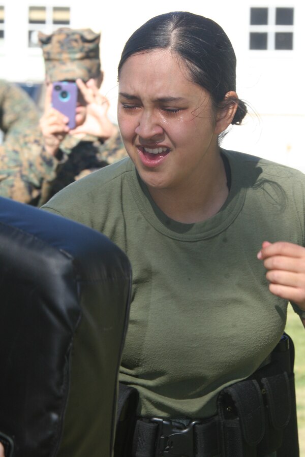 Lance Cpl. Chae Williams, correspondent clerk, Headquarters and Service Battalion, performs forward and reverse strikes on a bag during station four of a level one of Oleoresin Capsicum spray course Jan. 27 aboard Marine Corps Recruit Depot San Diego. Marines completed this course as a part of Security Augmentation Force training. This gave them a first hand experience on the OC spray effects and situations they may face.