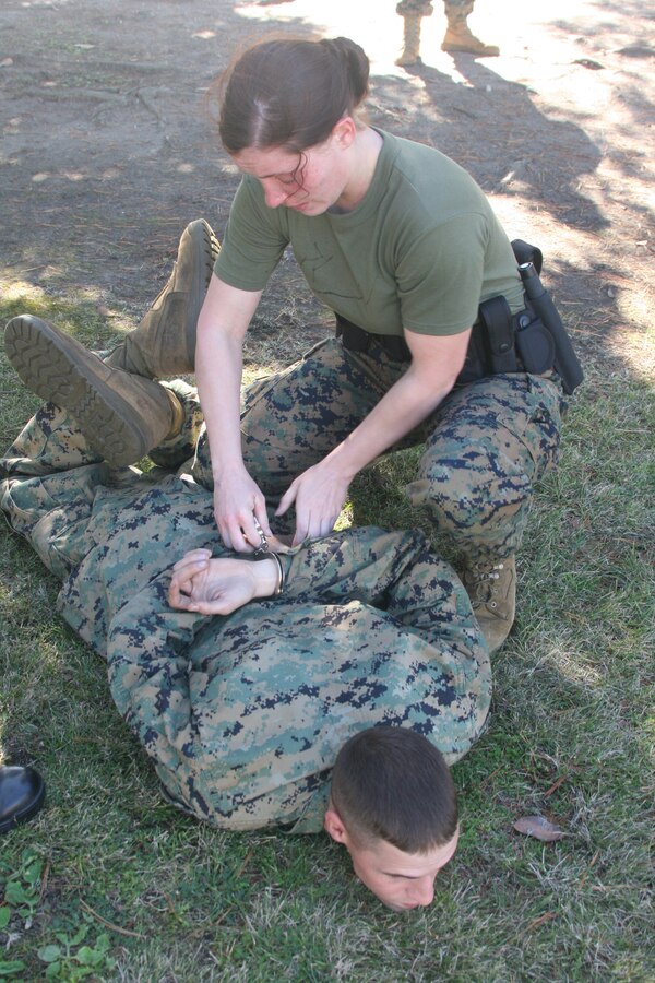 Lance Cpl. Bridget Keane, combat correspondant, Headquarters and Service Battalion, finished the last station of the level one Oleoresin Capsicum spray course by apprenhending Lance Cpl. Andrew Rodgers, the "suspect" Jan. 27 aboard Marine Corps Recruit Depot San Diego. To complete the course the Marines had to complete five stations while having OC spray in their eyes. This course was to teach the Marines the effects of the spray and how to fight through the pain.