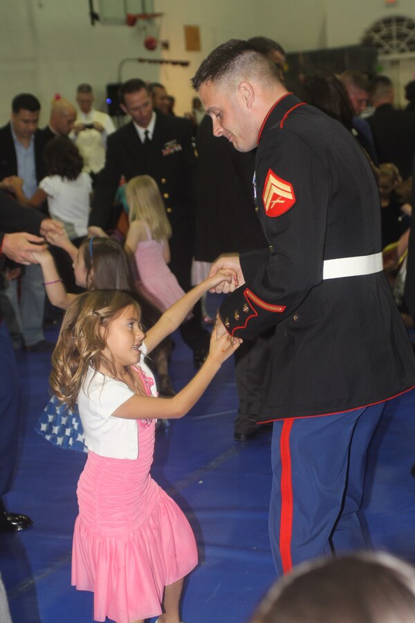 Cpl. David Clark, adminstration clerk, 12th Marine Corps District, accompanies his daughter on the dance floor at the Father Daughter Dance in the Semper Fit Fieldhouse aboard Marine Corps Recruit Depot San Diego Jan. 27. The fifth annual Father Daughter Dance was themed Sugar, Spice and Everything Nice and attracted 194 guests.