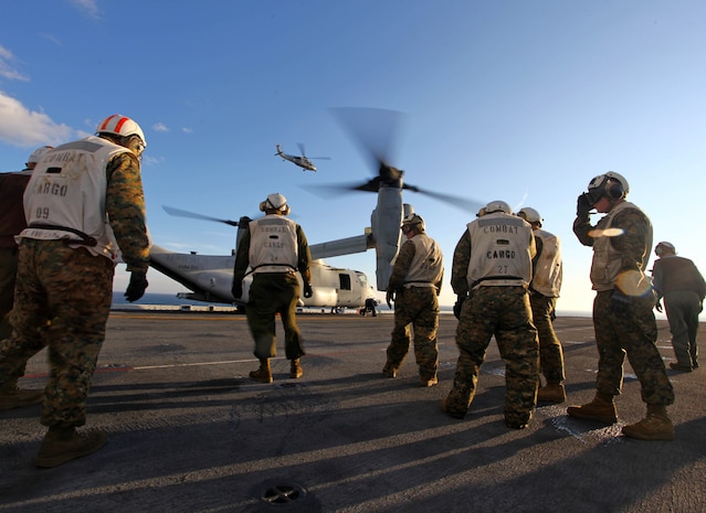 Combat Cargo Marines with Battalion Landing Team 1st Battalion, 2nd Marine Regiment, 24th Marine Expeditionary Unit, prepare to offload cargo from an MV-22 Osprey aboard the USS Iwo Jima Jan. 27, 2012 during onload operations as the 24th MEU prepares for their final at-sea training exercise. The 24th MEU is conducting their Certification Exercise (CERTEX) with Iwo Jima Amphibious Ready Group scheduled Jan. 27 to Feb. 17, which includes a series of missions intended to evaluate and certify the unit for their upcoming deployment.