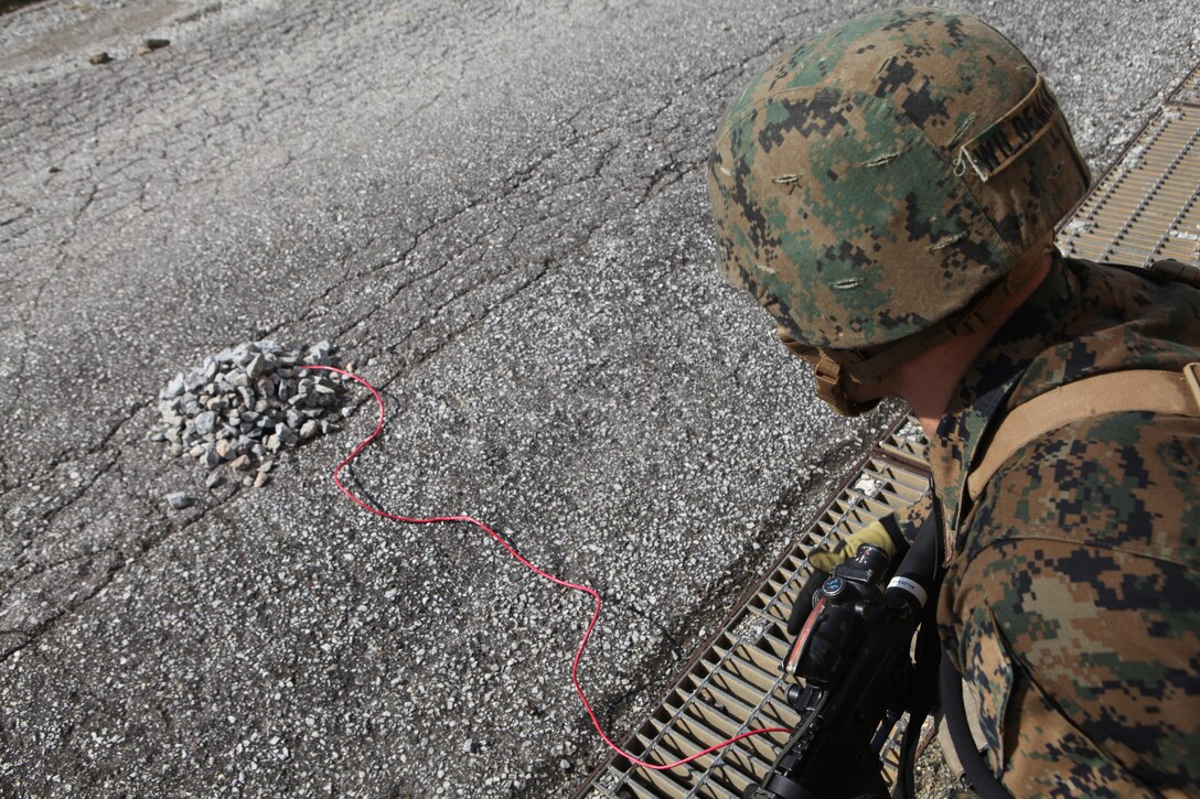 A Marine with Company B., Battalion Landing Team 1st Battalion, 4th Marines, 31st Marine Expeditionary Unit, inspects a possible improvised explosive device area during a mechanized raid exercise on the on the urban training facilities here , Jan. 28. The Marines conducted the raid during the MEU’s Amphibious Integration Training, in preparation for Exercise Cobra Gold 2012. The 31st MEU is the only continuously forward-deployed MEU and remains the Nations force in readiness in the Asia-Pacific region.