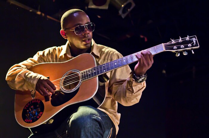 Cpl. Edward Wilson, a clerk for Headquarters Company, Combat Logistics Regiment 27, 2nd Marine Logistics Group, plays a guitar during a performance at a local club in Jacksonville, N.C., Jan. 28, 2012. As a musician Wilson not only performs, but donates a portion of his proceeds to charitable causes. (Photo courtesy of Jeffrey Kane)