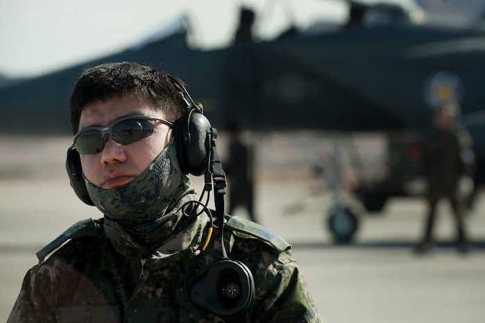 A Republic of Korea Air Force Airman watches as an F-15E Strike Eagle taxies out during Red Flag 12-2 Jan. 27, 2012, at Nellis Air Force Base, Nev. Red Flag is a realistic combat training exercise involving the air forces of the United States and its allies. The exercise is hosted north of Las Vegas on the Nevada Test and Training Range. (U.S. Air Force photo by Staff Sgt. Christopher Hubenthal) 
