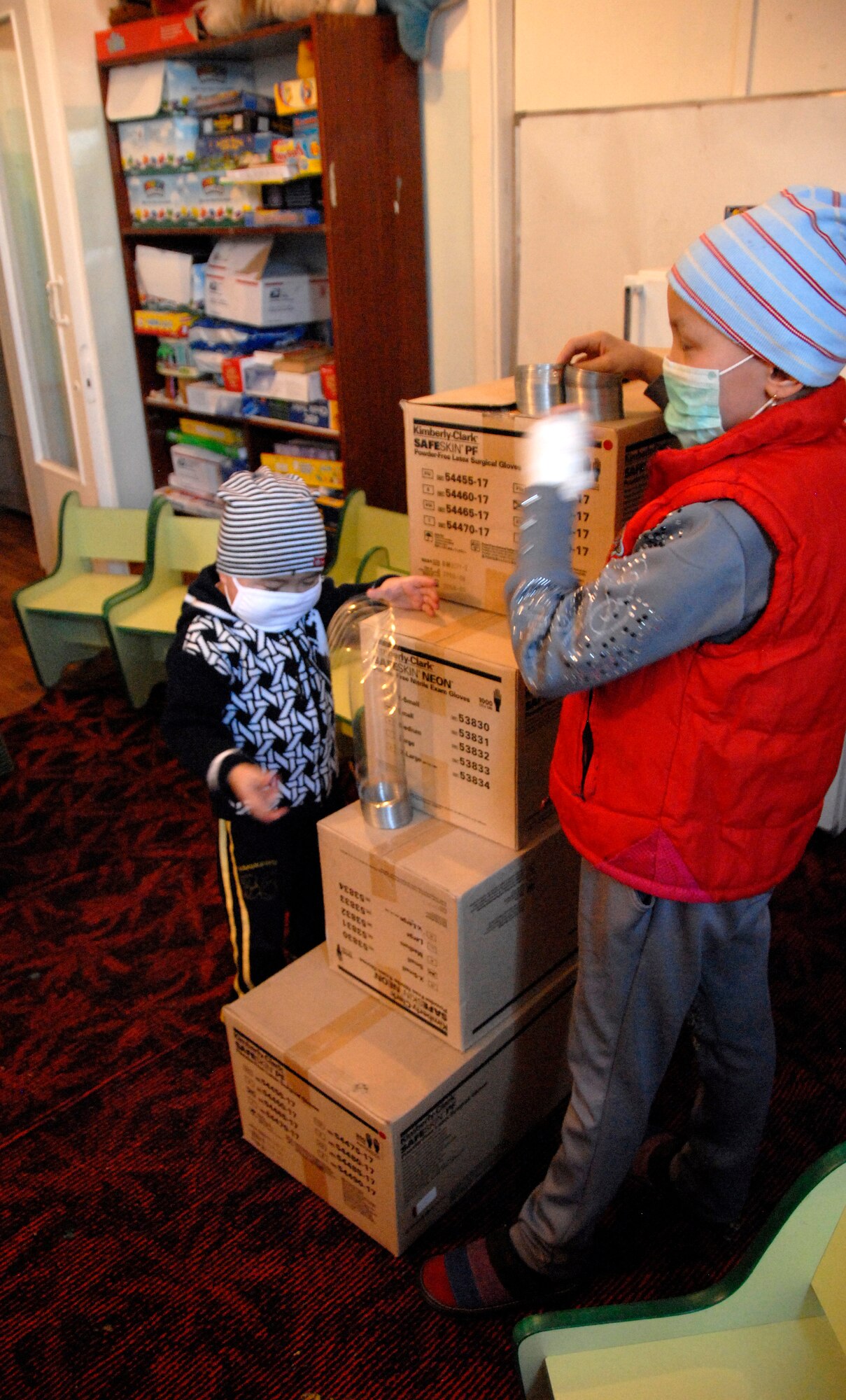 Abdymalik and Aizat race Slinkies down homemade stairs at the Children's Cancer Center in Bishkek, Kyrgyzstan, Jan. 25, 2012. A group of people from the Manas Area Benefit Outreach Society traveled to the cancer center to play with the children and bring them toys. (U.S. Air Force photo/Senior Airman Lynsie Nichols)