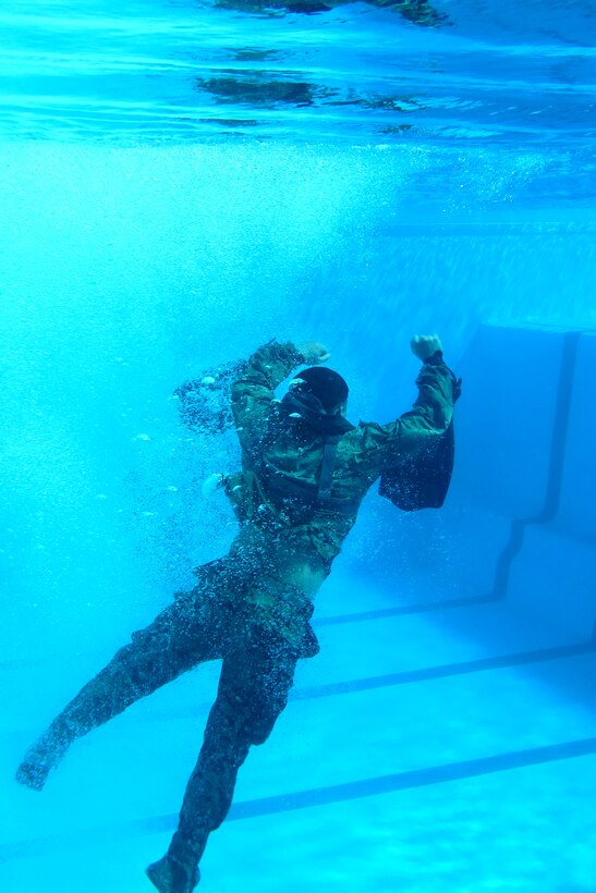 A Marine from Company A, 1st Recon Battalion, 1st Marine Division, jumps into a pool during a helocast preparation exercise aboard Camp Pendleton, Calif., Jan. 28, 2011. The event was part of Exercise Iron Fist 2012, a bilateral amphibious training exercise between the 15th Marine Expeditionary Unit and the JGSDF.