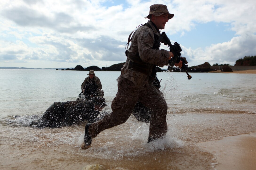 Scout swimmers with Company A, Battalion Landing Team 1st Battalion, 4th Marines, 31st Marine Expeditionary Unit, push onto the beach, Jan. 29. The Marines were conducting a small boat raid during the MEU’s Amphibious Integration Training in preparation for Exercise Cobra Gold 2012. The 31st MEU is the only continually forward-deployed MEU, and remains the nation's force-in-readiness in the Asia-Pacific region.