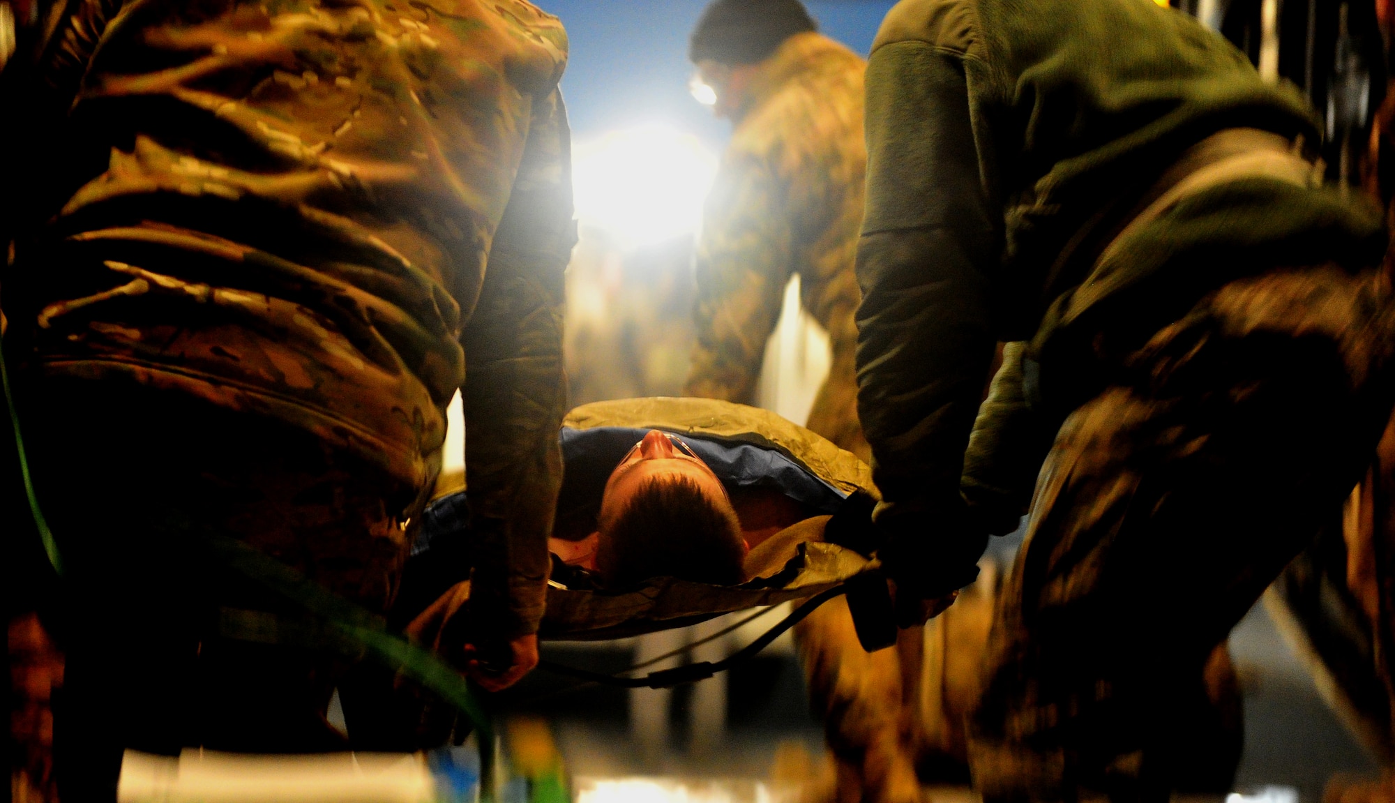 CAMP BASTION, Afghanistan -- Airmen assigned to the 76th Expeditionary Rescue Squadron offload a patient by litter from a HC-130 to an ambulance after a medical evacuation. The 76th ERQS serves as an ambulance of the air for Operation ENDURING FREEDOM. The squadron’s mission is to provide medical or casualty evacuation and personnel recovery for U.S. and coalition forces, Afghan National Security Forces and local nationals in all of the regional commands in Afghanistan. (U.S. Air Force photo/Senior Airman Tyler Placie)
