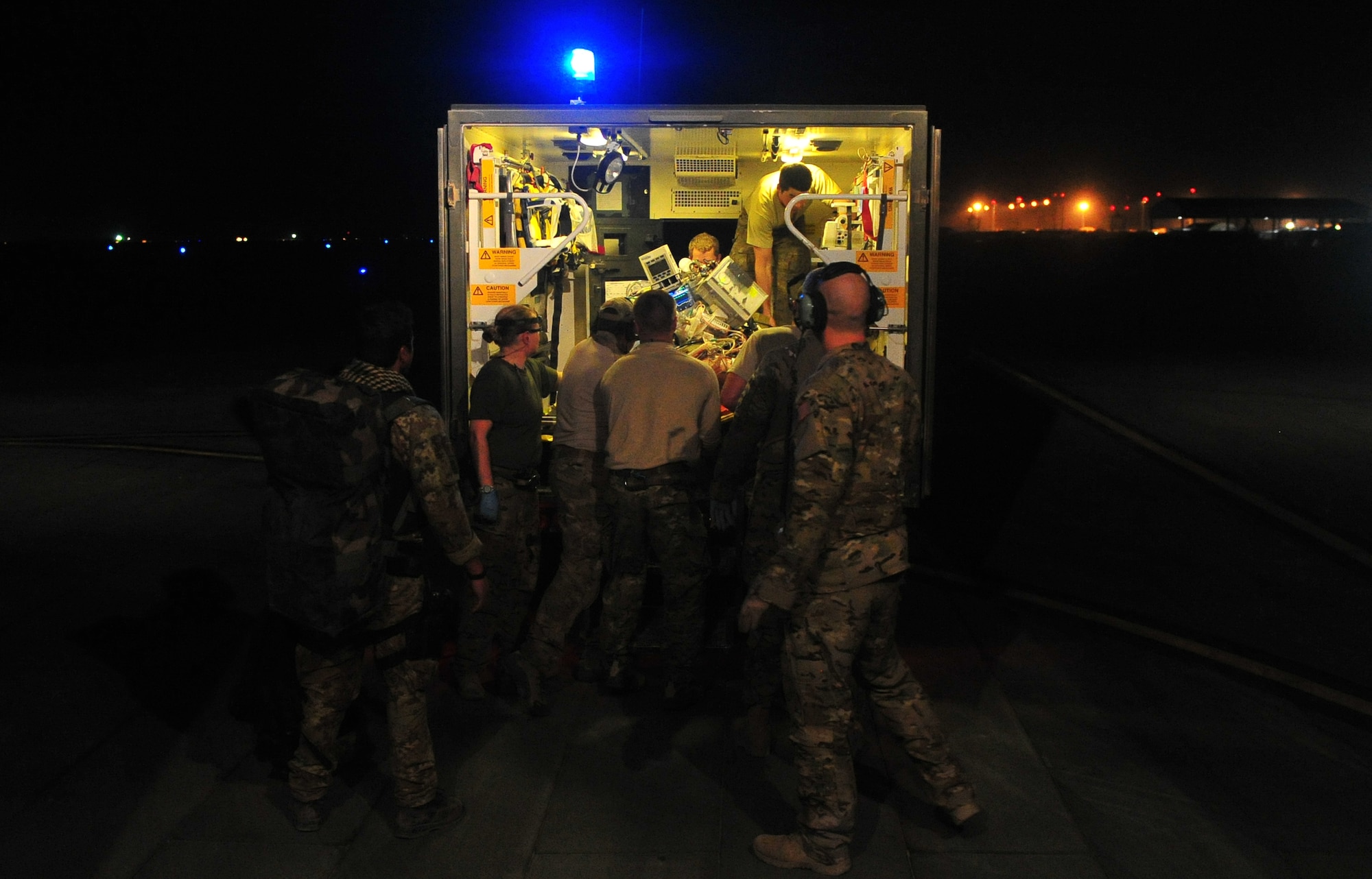 CAMP BASTION, Afghanistan – Airmen assigned to the 76th Expeditionary Rescue Squadron offload a patient by litter from a HC-130 to an ambulance after a medical evacuation. The 76th ERQS serves as an ambulance of the air for Operation ENDURING FREEDOM. The squadron’s mission is to provide medical or casualty evacuation and personnel recovery for U.S. and coalition forces, Afghan National Security Forces and local nationals in all of the regional commands in Afghanistan. (U.S. Air Force photo/Senior Airman Tyler Placie)