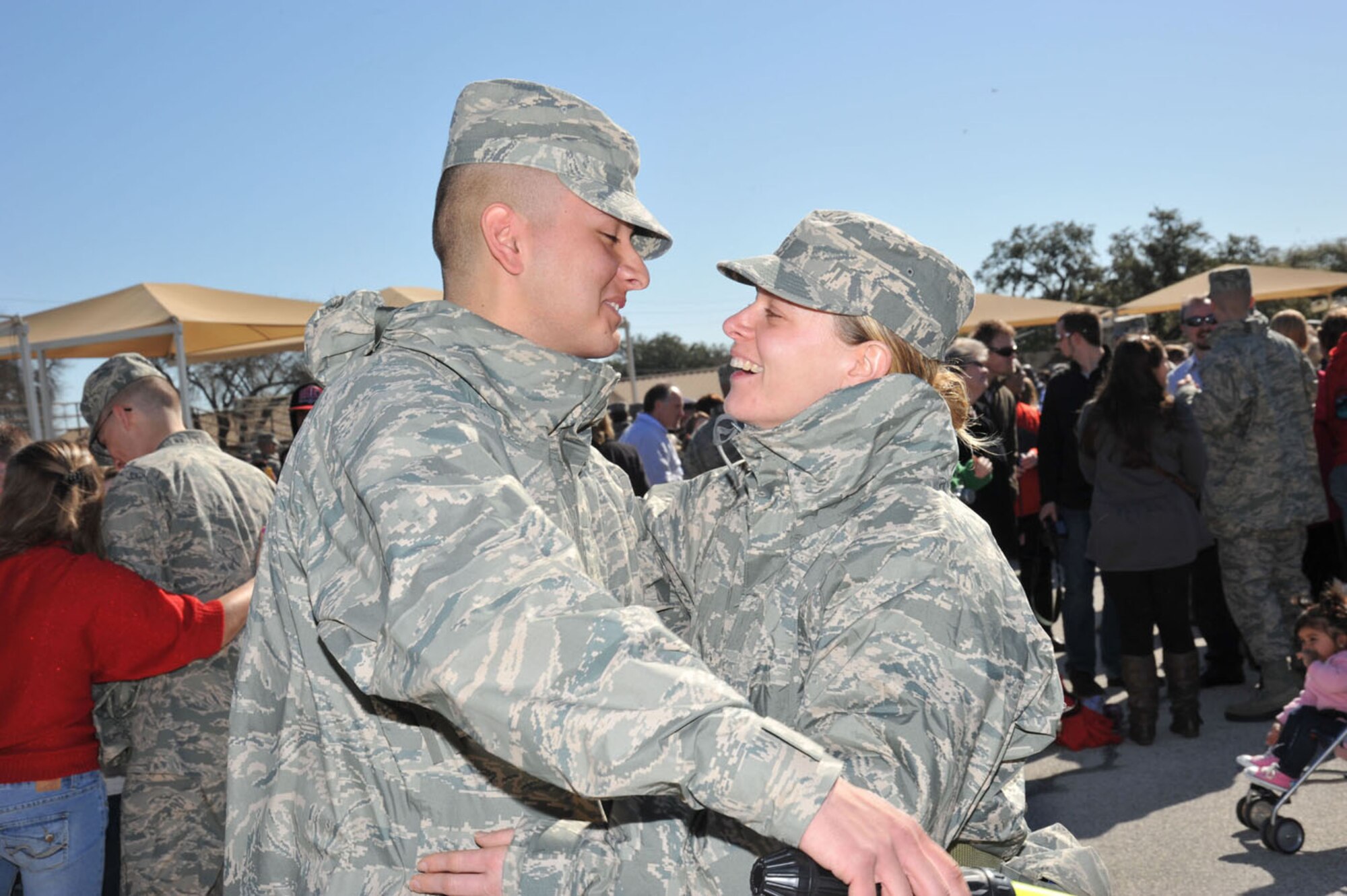Airman Basic Justus Sanchez hugs his mother, Air Force basic trainee Lori Huayacla, following the Airman Coin and Retreat Ceremony Thursday at Joint Base San Antonio-Lackland. The ceremony symbolizes a service member's transition from basic trainee to Airman. (U.S. Air Force photo/Alan Boedeker)