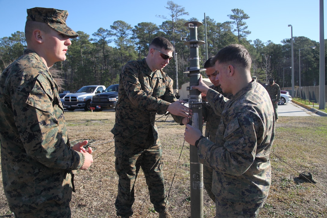 Cpl. Jay Joseph, a digital multi-channel wideband transmission equipment operator with Marine Wing Communications Squadron 28, instructs Marines how to install the AN/MRC-142C digital wideband transmission system, during operation Grizzly Spartan at MWCS-28 Jan. 30. The AN/MRC is an integrated multi-channel system that provides two-way secure digital wideband transmissions with two radios per system, according to www.marcorsyscom.usmc.mil.