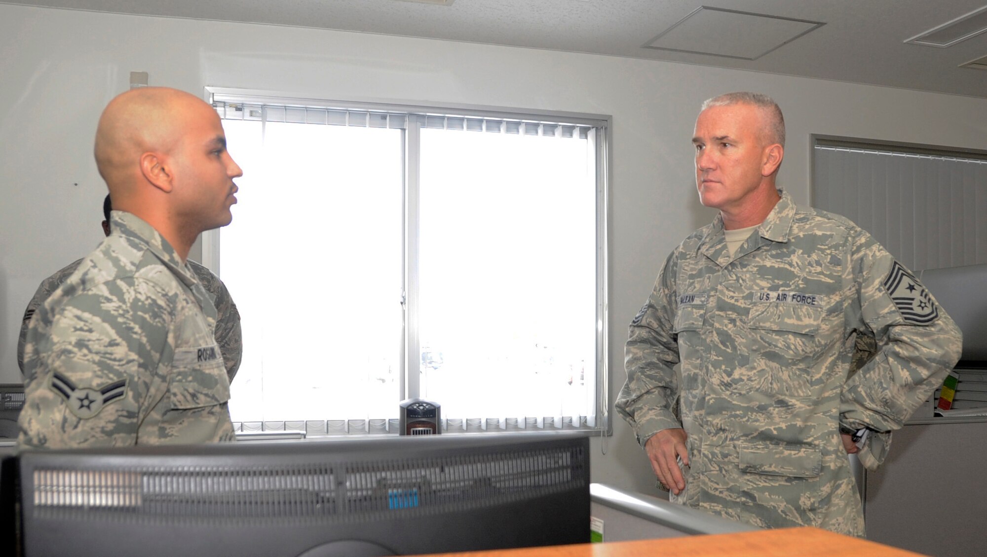 MISAWA AIR BASE, Japan -- Airman 1st Class Luis Rosario, 35th Communication Squadron client system technician, briefs Chief Master Sgt. Brooke McLean, Pacific Air Forces command chief, about current events in the 35 CS here, Jan. 25. McLean toured base facilities and spoke with enlisted Airmen during his visit to Misawa. (U.S. Air Force photo/Airman 1st Class Kaleb Snay)